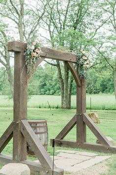 an outdoor ceremony setup with flowers and greenery