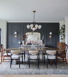 a dining room table with chairs and a chandelier