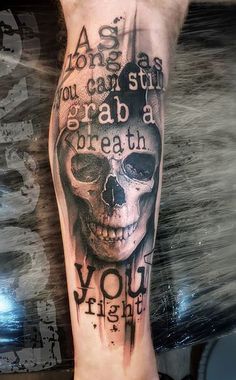 a man's leg with a skull and words on it