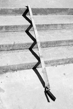 a black and white photo of some steps with a tie on it's side