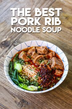 the best pork rib noodle soup in a white bowl on a wooden table with chopsticks