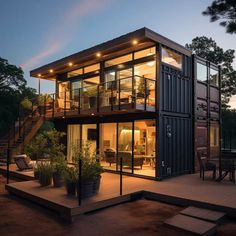 a house made out of shipping containers is lit up at night