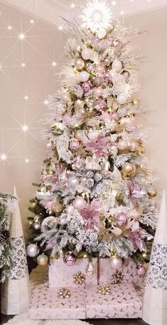 a pink christmas tree with presents under it