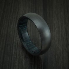 Black Zirconium and Indigo Wood Hard Wood Sleeve Ring Custom Made Classic Titanium Ring With Polished Finish, Black Promise Ring With Polished Finish, Black Titanium Round Jewelry, Black Titanium Anniversary Rings, Black Polished Round Band Rings, Titanium Rings With Polished Finish, Formal Black Titanium Jewelry, Black Titanium Jewelry With Polished Finish, Modern Black Titanium Jewelry