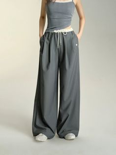 Unwind in style with our Relaxed Fit Drawstring Waist Wide Leg Pants. These pants offer the perfect combination of comfort and fashion, with a relaxed fit and adjustable drawstring waist. The wide leg design adds a trendy twist to any look. Get ready to lounge or hit the town in these versatile pants. Material: 60% Polyester 35% Cotton 5% Spandex Size Chart: Size Waist (cm) Hip (cm) Length (cm) S 64 100 104 M 68 104 105.5 Note: All measurements are in centimeters (cm). Baggy Wide-leg Harem Pants For Leisure, Baggy Wide Leg Harem Pants For Leisure, High Waist Drawstring Leisure Pants, Leisure High Waist Drawstring Pants, Leisure High-waist Drawstring Pants, Casual Gray Wide Leg Harem Pants, Trendy Gray Pants With Drawstring, Relaxed Fit Wide Leg Pants With Drawstring, Gray Wide Leg Drawstring Bottoms