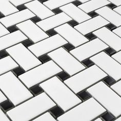 a close up view of white and black tiles