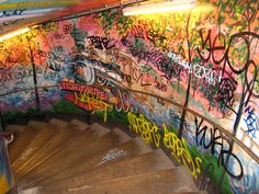 the stairs are covered in graffiti and have been painted with various colors, shapes and sizes