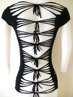 the back of a dress made out of black string and white mannequins