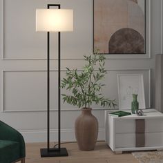 a living room scene with focus on the floor lamp and potted plant next to it