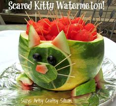 there is a watermelon carved to look like a cat