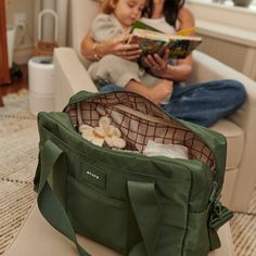 Designed for parents, by parents and packed with features to keep you organized on the go- including an insulated interior bottle pocket, a changing pad, a slip pocket for your phone, and hooks that easily attach to your stroller, plus a travel sleeve for easy travel. Inside, you'll find a separate padded compartment that fits up to a 14" laptop and a back pocket that can accommodate up to a 13" iPad. The main compartment offers two large mesh pockets with elastic—perfect for holding diapers and Casual Nylon Diaper Bag For On-the-go, Black Diaper Bag With Zipper Pocket For Travel, Nylon Diaper Bag With Zipper Pocket, Tote Style, Versatile Nylon Diaper Bag For On-the-go, Rectangular Diaper Bag With Pockets For On-the-go, Bringing Baby Home, Barbie Kids, Newborn Essentials, Embroidery Shop