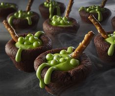 chocolate cupcakes decorated with green icing and sprinkles on sticks