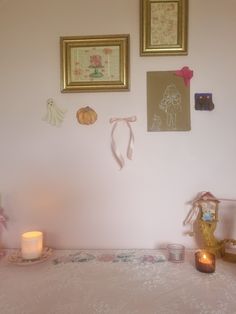 a table with candles and pictures on the wall