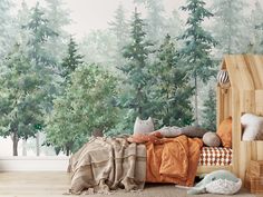 a bedroom scene with focus on the bed and forest wallpaper, along with stuffed animals