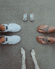 four people standing in a circle with their feet on the ground and one person wearing sandals