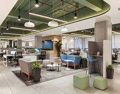 an office filled with lots of desks and chairs