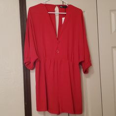 Has 2 Non Functional Red And Gold Buttons, One Button Closure In Back, Batwing Sleeves Elastic At End Of Sleeves, Sleeves Fall Under Elbow, Elastic At Waist Waist 15.5 In Total Length 31 In Sleeve To Sleeve 42in Waist To Hem 15.5 In Chic V-neck Jumpsuits And Rompers With Button Closure, Chic V-neck Jumpsuits And Rompers With Buttons, Red Solid Color Jumpsuits And Rompers For Spring, Red V-neck Jumpsuit And Romper, Red Solid Color Jumpsuits And Rompers For Night Out, Red Solid Color Jumpsuit For Night Out, Chic V-neck Jumpsuits With Buttons, Solid V-neck Jumpsuits And Rompers With Buttons, Solid V-neck Jumpsuit With Buttons