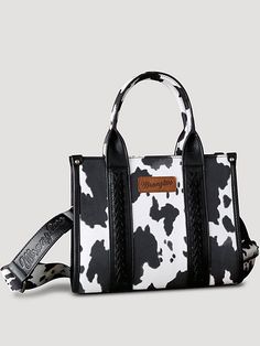 Allover cow print on canvas Whipstitch details Wrangler logo applique on the front Top zipper closure Inside of the bag includes a zippered pocket and 2 open pockets Double round handle (drop: 5.75") Detachable/adjustable cross body strap included 10.5" X 5" X 8.5" (Cross body strap 46" ) Wrangler Tote Bag, Casual Everyday Bag With Cow Print, Casual Cow Print Bags For Daily Use, Cowgirl Core, Cow Print Bag, Western Bag, Country Hats, Wrangler Accessories, Round Handle