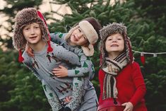 three children in winter clothing standing next to each other