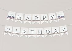 happy birthday bunting banner with train on the front and back, hanging from string