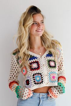 You'll be ready for dreamy days in the sun when you've got the Vibrant Crush Ivory Crochet Knit Top! This top features an array of bright, cheerful colors woven into an intricate crochet knit pattern, creating a unique, eye-catching design that adds texture and personality to any outfit. The button-front style offers versatility and ease of wear, allowing you to style it open over a tank or buttoned up for a more polished look. Crafted from soft, breathable yarn, this top provides comfort while Multicolor Open Knit Sweater For Vacation, Bohemian Multicolor Sweater For Beach, Bohemian Multicolor Beach Sweater, Multicolor Bohemian Beach Sweater, Multicolor Open Knit Beach Sweater, Multicolor Summer Sweater For Vacation, Multicolor Vacation Sweater For Spring, Bohemian Multicolor Granny Square Top, Spring Beach Sweater In Multicolor