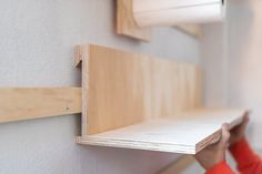 French cleats are a secure and easy way to hang heavy items on your walls. Learn how to make them with this easy-to-follow DIY guide. They only take minutes to make and are budget-friendly, too. This tutorial covers everything you need to know. It includes the kind of wood and saw to use and contains helpful tips to achieve a perfect result. French cleats are perfect for organising your home, too. They’re ideal for creating flexible storage in workshops, garages, or cellars. French Cleat Bookshelf, French Cleat Shelf, French Cleat Shelves, Diy French Cleat, Floating Nightstand Ideas, French Cleat Wall, Modern Floating Nightstand, French Cleat System, French Cleats