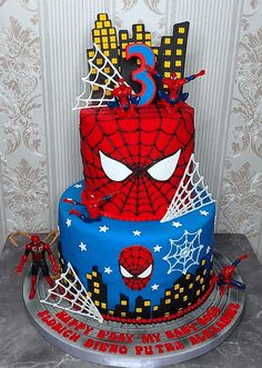 a spiderman themed birthday cake with the number three on it's top tier