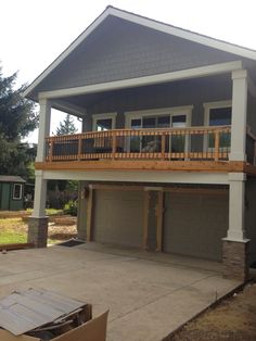 a two car garage with an attached balcony