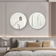 two circular mirrors mounted on the wall above a bed in a room with beige walls