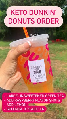 a person holding up a plastic cup with a straw in it that says keto dunkin'donuts order