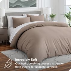 an image of a bed that is made up with comforters and pillows on it