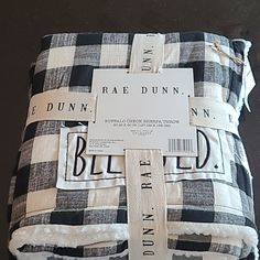 a black and white checkered blanket with tags on it