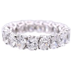 a white gold ring with five diamonds on the side and four rows of round brilliant cut stones