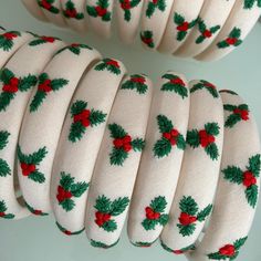 white christmas ribbon with holly and red berries on it, sitting next to each other