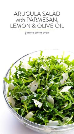 arugula salad with parmesan, lemon and olive oil in a glass bowl