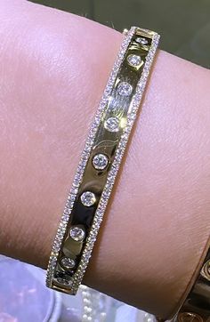 This best-selling style boasts a polished gold finished inlaid with 115 sparkling round-cut diamonds. Two rows of glittering diamonds line this bangle - a great piece to wear alone or as the anchor of a stack. An instant classic that will become your signature. Metal: 18K Yellow Gold Diamond Weight: 1.10ct t.w.Diamond Shape: 115 Round Brilliant cutsSetting: Burnish / InlayBangle Width: 46 x 58mm L: 7mm Estimated production time is 4 - 5 weeks. Jewelry Accessories Ideas, The Anchor, Diamond Glitter, Accessories Ideas, Diamond Shape, Round Cut Diamond, Round Brilliant, Bangle Bracelet, Gold Finish