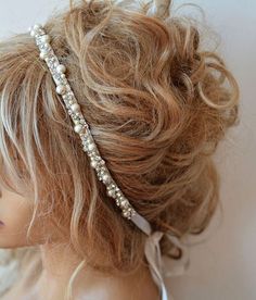 a woman's head wearing a hair band with pearls