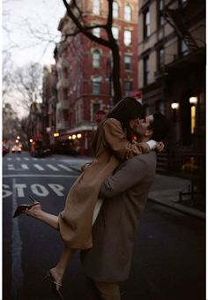 a man carrying a woman on his back down the street