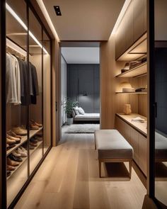 a walk - in closet with wooden shelves and shoes on the floor next to it