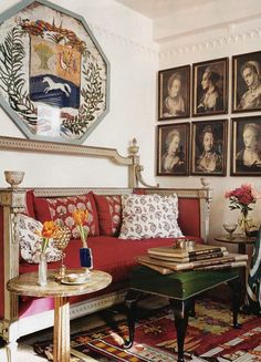 a living room filled with furniture and pictures on the wall