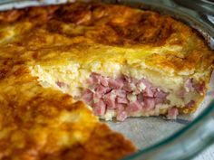 a close up of a pie with meat in it