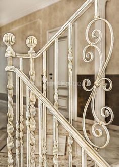 an ornate white iron stair railing in a house