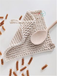 a knitted dish cloth with a wooden spoon on it