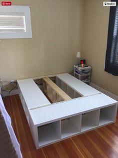 a bed room with a wooden floor and a window in it's side wall