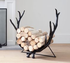 a stack of logs sitting on top of a wooden floor