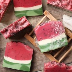 watermelon and raspberry soap bars on a wooden table