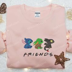 a pink shirt that says friends with two cartoon characters on the front and one is holding a star