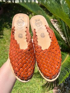 COLOR: BRICKUPPER: LEATHERSOLE: CREPE Handmade huaraches from Michoacán, Mexico. Made with 100% leather. SIZING *Please refer to sizing chart*If you wear a half-size shoe we recommend sizing down (ex: Your shoe size is 7.5, size down to size 7)If you have a wide foot, For example, your shoe size is 7.5 then size up for a more comfortable fit. Leather stretches and will mold after a few uses*Please advise since all of our huaraches are handmade with genuine leather minor wrinkles and markings mig Brown Leather Mules With Woven Sole, Brown Woven Leather Huarache Sandals, Closed Toe Leather Woven Mules, Adjustable Brown Mules With Leather Footbed, Closed Toe Leather Mules With Woven Design, Casual Woven Leather Mules With Flat Heel, Casual Adjustable Closed Toe Mules, Leather Huarache Sandals With Woven Sole, Casual Closed Toe Woven Leather Mules