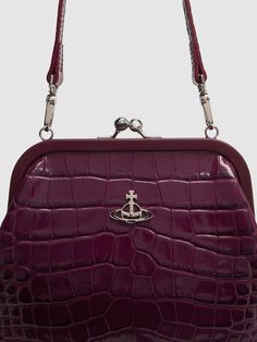 Height: 18cm Width: 23cm Depth: 24cm. Strap drop: 20cm. Detachable shoulder strap. Metal frame with clasp closure. Logo detail. All over pattern placement may vary Elegant Evening Bags With Embossed Details, Elegant Embossed Evening Bags, Formal Embossed Shoulder Bag, Vivienne Westwood Clutch, Purple Clutch, Velvet Clutch, The Vivienne, All Over Pattern, Leather Clutch Bags