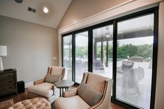 a living room filled with furniture next to sliding glass doors that look out onto a patio